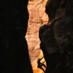 a man climbing up the side of a cliff